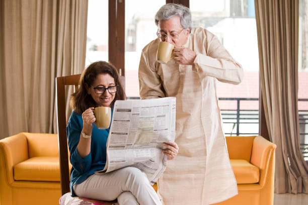 istock Senior couple reading newspaper and drinking coffee 1150107986