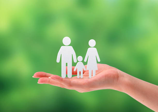 istock family in a hand, green background 1150108004