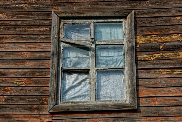 istock one old window on a brown wooden  wall 1150111945