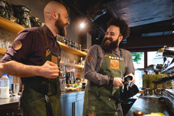 istock Cheerful baristas making espresso at work 1150112963