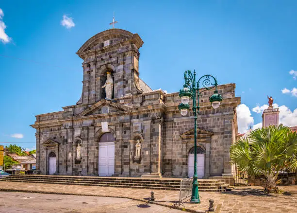 Bight and colorful image with cathedral in city centre of Basse Terre, Guadeloupe. Blue sky.