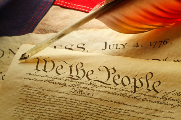 istock Feather Quill On U.S. Constitution And American Flag 1150115038