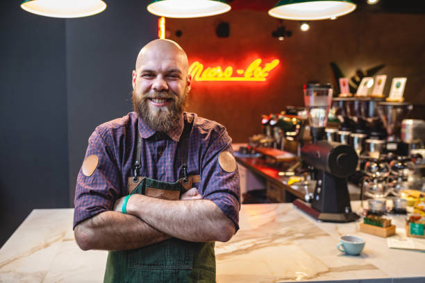 istock Cheerful coffee shop worker at his work place 1150117783