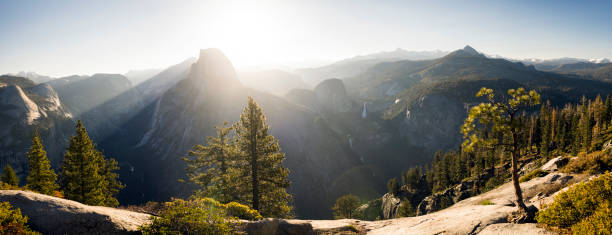 istock Panoramic sunrise over Half Dome in eary spring with waterfall 1150117803