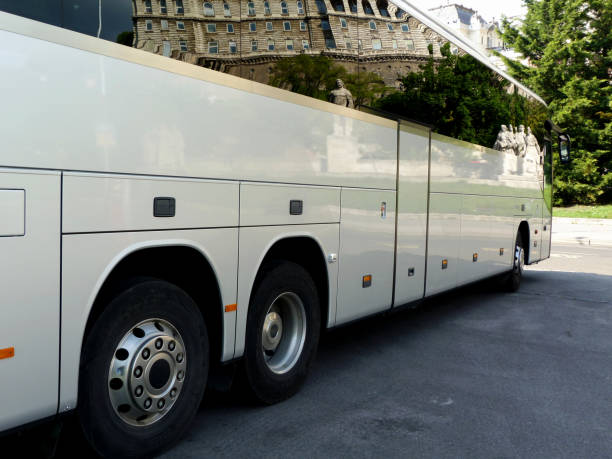 istock white tour bus with dark windows reflecting the castle building in Budapest 1150117899