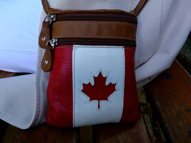istock red maple leaf symbol in white stitched leather woman's purse 1150117909