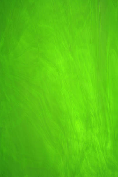 Bright Green Stained Glass A pane of Bright Green Stained Glass, smokey texture. coloured glass texture stock pictures, royalty-free photos & images
