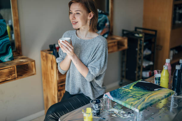 istock Woman drinking coffee in art studio 1150120666