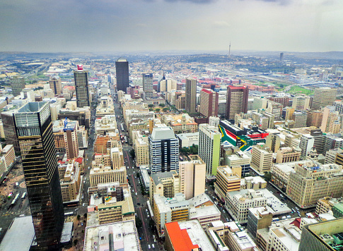 Aerial View of Downtown Johannesburg and Large South African Flags on Sides of Building - Johannesburg, South Africa