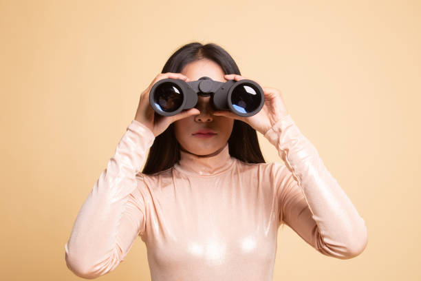 istock Young Asian woman with binoculars. 1150124690