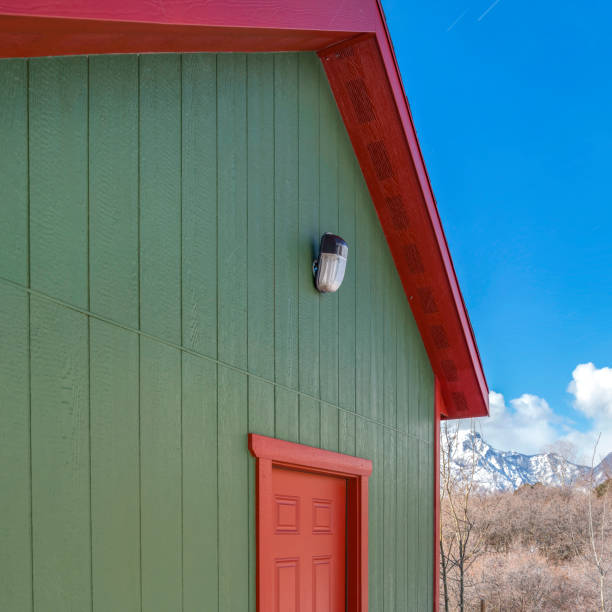 istock Square Storage shed against trees and snow capped mountain under cloudy blue sky 1150134226
