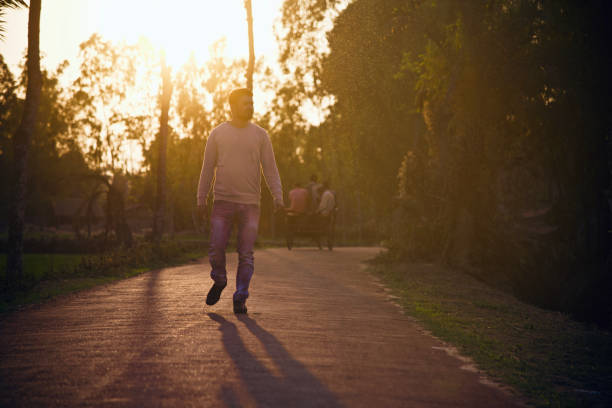 istock Man in a blue jeans walking in the street 1150134270