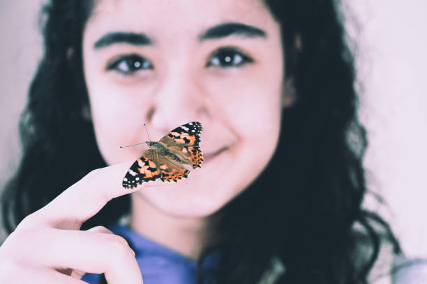 istock girl and beautiful butterfly 1150134551