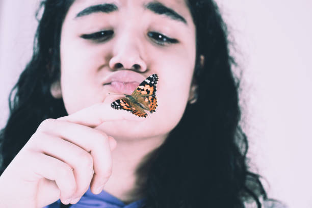istock girl and beautiful butterfly 1150134552