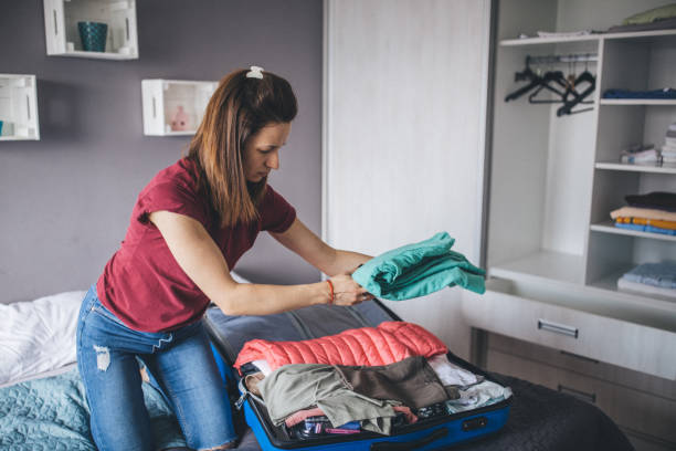 istock Woman packing clothes for the trip 1150134584
