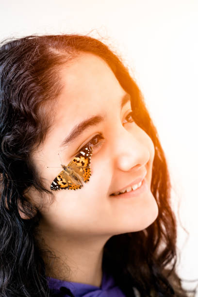 istock girl and beautiful butterfly 1150134737