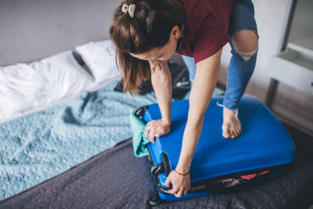 istock She is always struggling with over-packed suitcase 1150135424