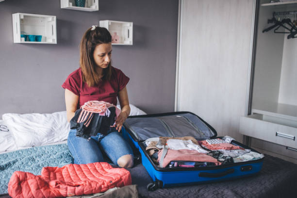 istock Woman preparing clothes for vacation 1150135462