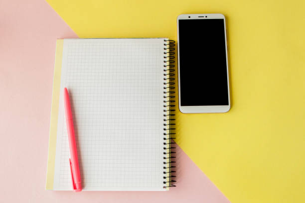 istock Creative flat lay photo of workspace desk with smartphone,and notebook with copy space background, minimal style 1150135558