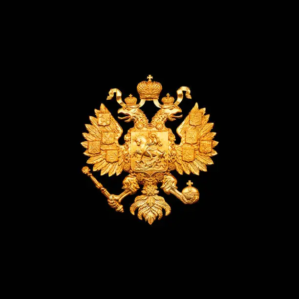 Photo of Gold double eagle isolated on black background. Russian coat of arms