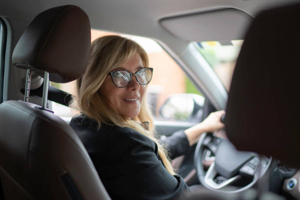 istock Female driver looking over the should into the camera 1150136493