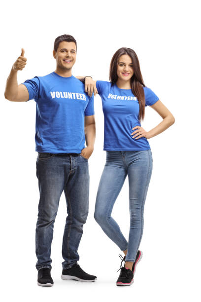 Young volunteers posing and showing thumbs up
