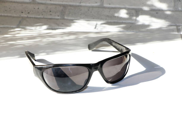 istock Black sunglasses on a white background with a shadow. 1150137477