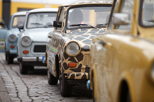 Trabant cars parked on the street are waiting for customers to take a ride with the iconic historic car of the former GDR.