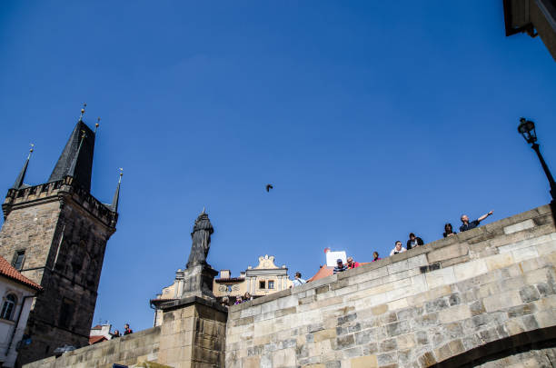 View of people on Charles bridge seen from below during day of springtime