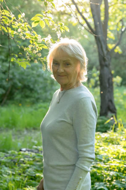 istock Happy elderly woman in a sunny park 1150142117