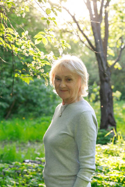 istock Happy elderly woman in a sunny park 1150142119