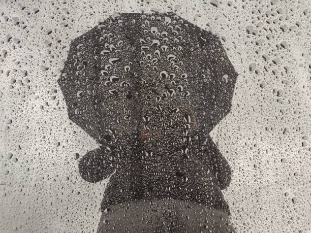 istock Man silhouette at the rain. 1150142932