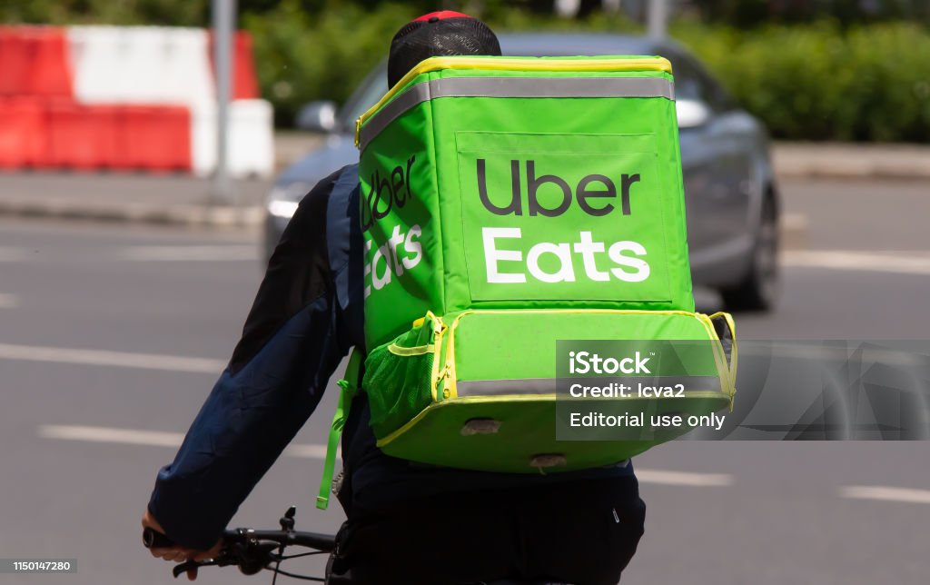 Food delivery courier - Bucharest Bucharest, Romania - May 12, 2019: An Uber Eats food delivery courier delivers food in Bucharest, Romania. Uber Eats Stock Photo