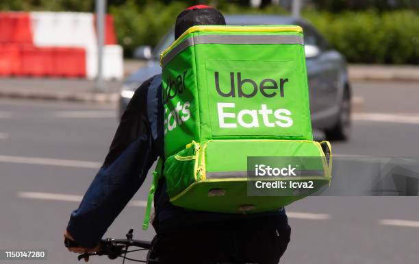 Food Delivery Courier Bucharest Stock Photo - Download Image Now - Uber Eats, Delivering, Food