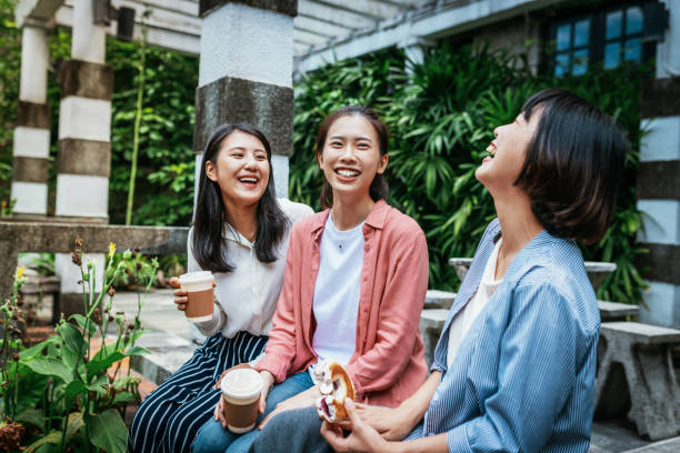 istock Millennial generation Asian women drinking coffee and laughing. 1150151351