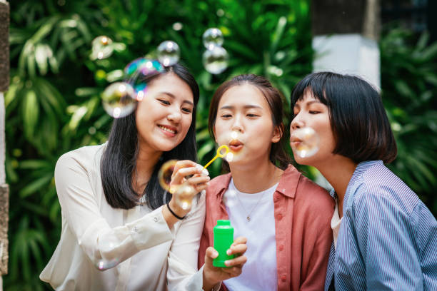 istock Millennial generation Chinese women blowing bubbles. 1150153438