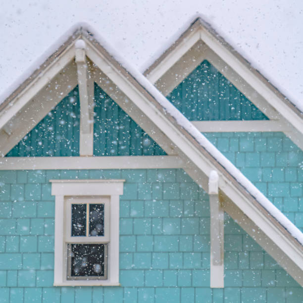 istock Square Snow falling on a blue home in Daybreak Utah with cloudy sky in the background 1150156466