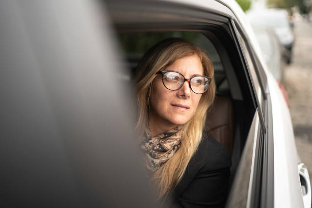 istock Mature woman looking through car window 1150158594