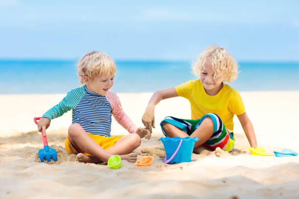 istock Kids playing on beach. Children play at sea. 1150164871