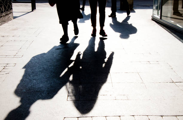 istock Blurry shadow silhouette of  people walking 1150165640