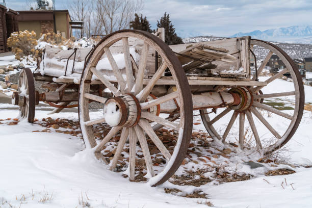 istock Weathered wagon against a scenic landscape blanketed with snow in winter 1150167258