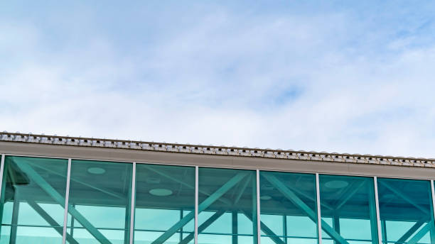 istock Clear Panorama Looking up at an empty skybridge with a cloudy blue sky in the background 1150167327