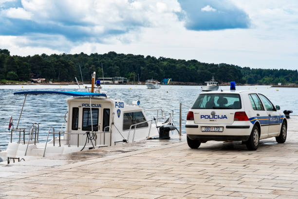 Croatian police car and police boat in the harbor of Porec stock photo