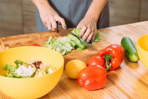 istock woman hands cutting lettuce healthy balanced salad 1150170651