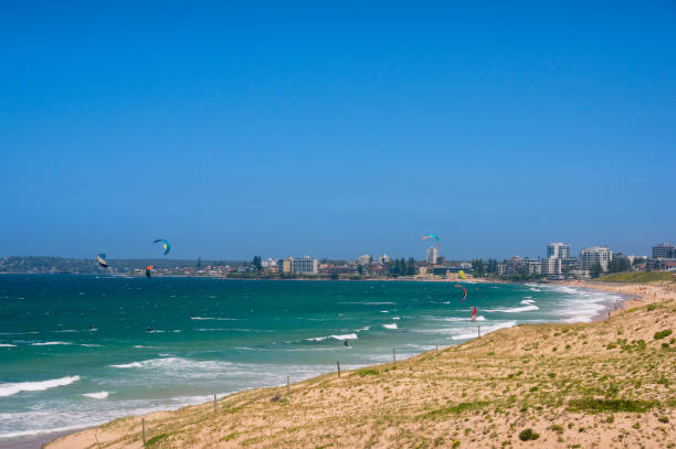 istock Panoramic beach with colorful kite surfers parachutes 1150171035