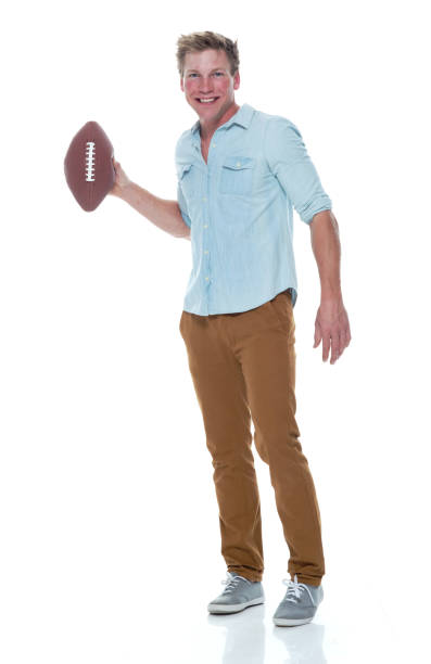 istock Casually dressed man holding a football 1150174017
