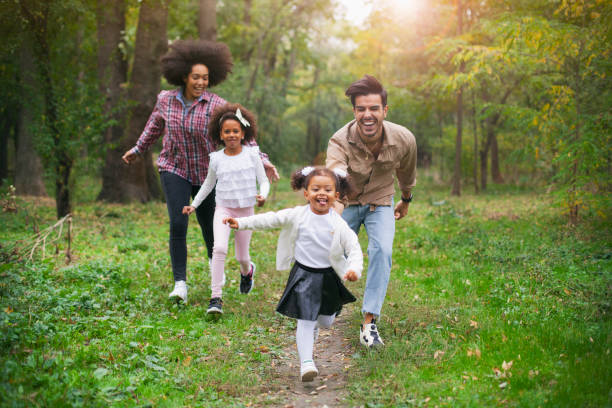 istock Carefree family having fun while running in spring day outdoors. 1150174321
