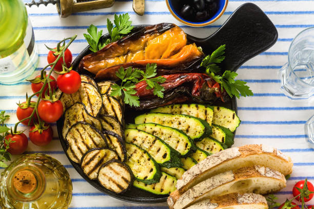 istock grilled vegetables on the table with white wine, fresh bread and aromatic herbs. summer menu 1150175003