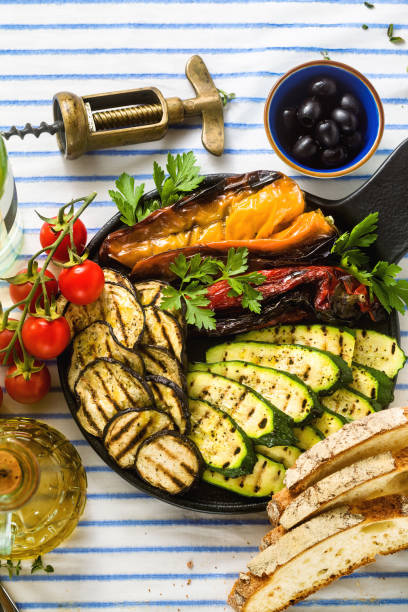 istock grilled vegetables on the table with white wine, fresh bread and aromatic herbs. summer menu 1150175011