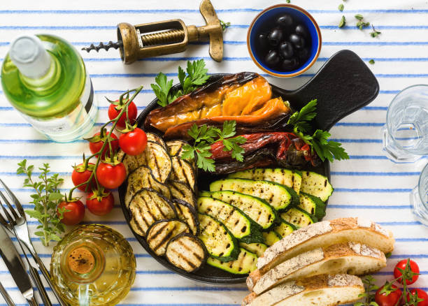 istock grilled vegetables on the table with white wine, fresh bread and aromatic herbs. summer menu 1150175017